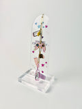 arched clear acrylic bookmark with charms that have game console, yellow star, drink bottle. The bookmark has keyboard, game console and tumbler with peach and pink color aesthetics standing on white background.